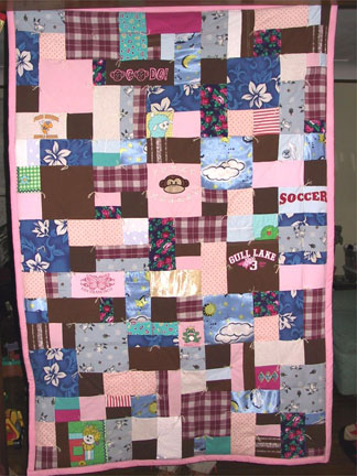 06st-lap1.jpg - Lap size quilt made of a variety of shapes and sizes from childhood clothing and baby items